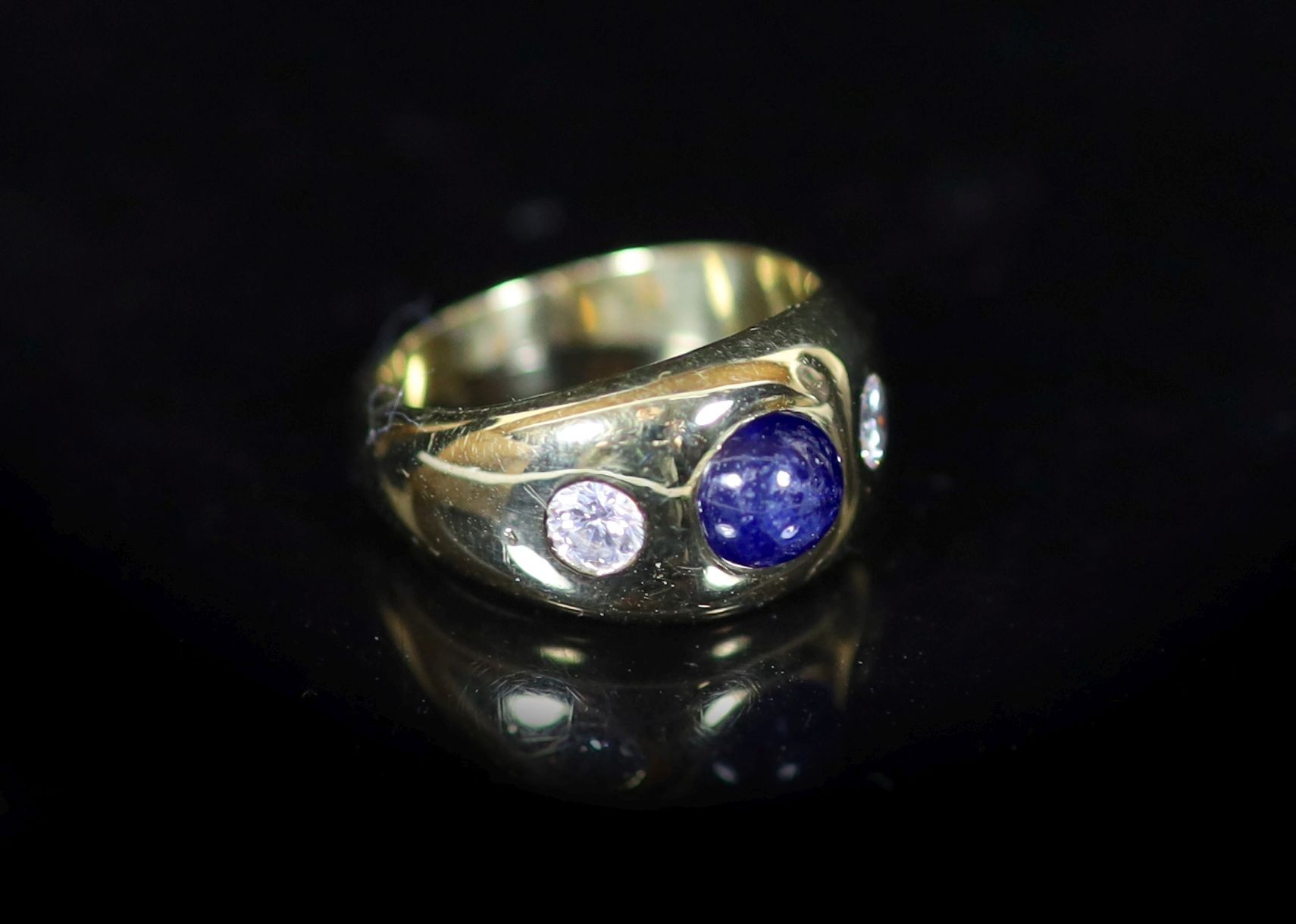 A Cartier 18ct gold , gypsy set cabochon sapphire and two stone diamond ring